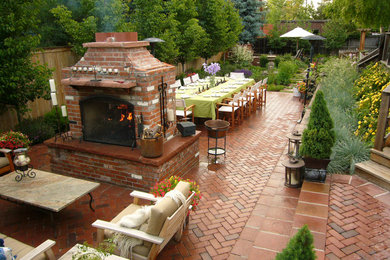 Design ideas for a medium sized classic back patio in Denver with brick paving, a fire feature and no cover.