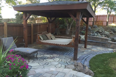 Inspiration for a backyard concrete paver patio remodel in Denver