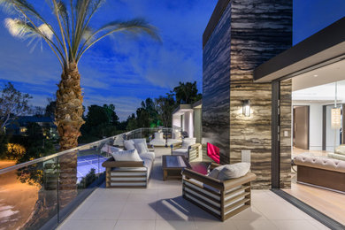 Inspiration for a large modern side yard tile patio remodel in Orange County with no cover