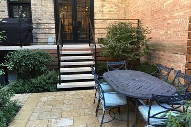 Small elegant backyard stone patio photo in Chicago