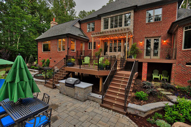 Patio - mid-sized traditional backyard stone patio idea in Richmond with a pergola