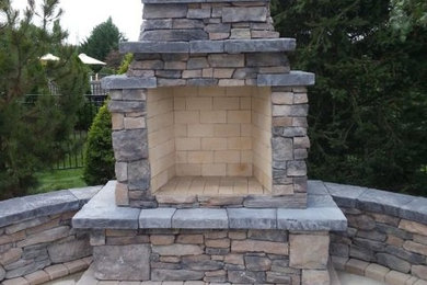 Example of a backyard patio design in Philadelphia with a fire pit