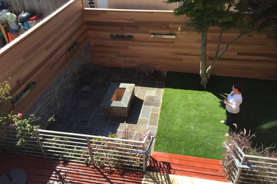 Mid-sized minimalist backyard concrete paver patio photo in San Francisco with a fire pit and no cover