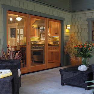 Example of a large trendy backyard concrete patio design in San Diego with a roof extension