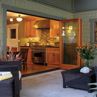 Patio - large craftsman backyard concrete patio idea in Los Angeles with a roof extension