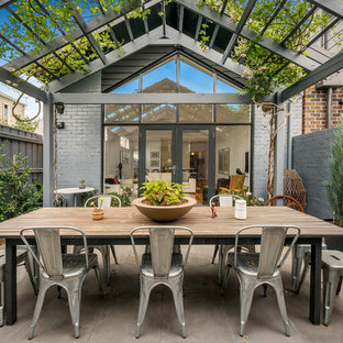 Design ideas for a country backyard patio in Melbourne with concrete slab and a pergola.