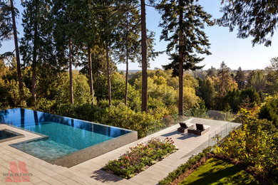 Example of a huge trendy backyard tile patio fountain design in Vancouver with no cover