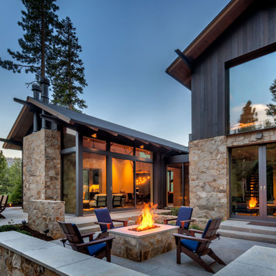 Large mountain style backyard stone patio photo in Sacramento with a fire pit and no cover