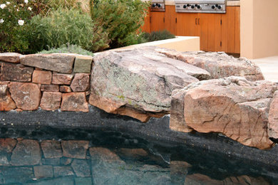 Inspiration for a southwestern backyard stone patio kitchen remodel in Albuquerque