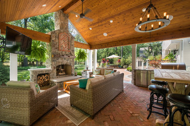 Inspiration for a contemporary backyard brick patio kitchen remodel in Cleveland with a gazebo