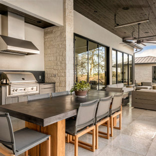 Inspiration for a contemporary tile patio kitchen remodel in Austin with a roof extension