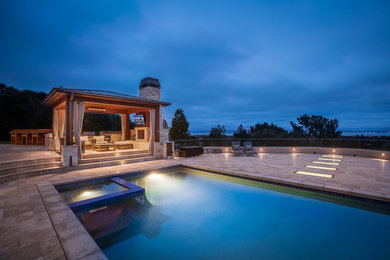 Photo of an expansive classic swimming pool in San Francisco with natural stone paving.