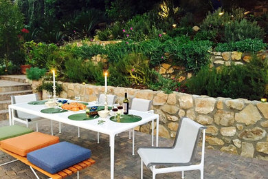 Inspiration for a mid-sized timeless backyard stone patio kitchen remodel in Los Angeles with no cover