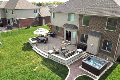 Inspiration for a large backyard brick patio remodel in Detroit with no cover