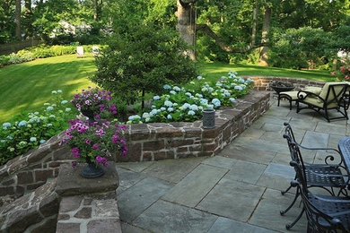Design ideas for a large traditional back patio in Bridgeport with a fire feature.