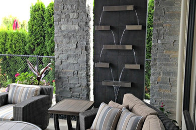 Inspiration for a contemporary patio fountain remodel in Vancouver