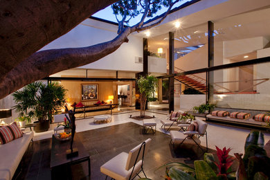 Inspiration for a mid-sized contemporary courtyard concrete patio remodel in Los Angeles