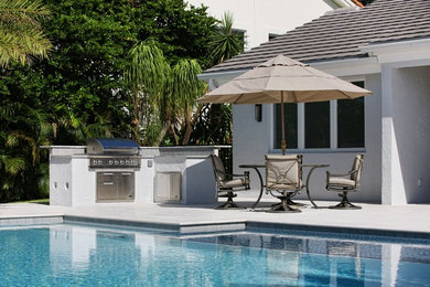 Example of a large backyard patio design in Miami