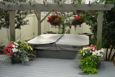 Design ideas for a back patio in Calgary with a water feature and an awning.
