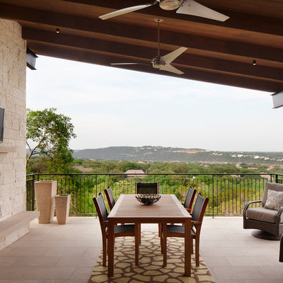 Inspiration for a mid-sized contemporary side yard tile patio remodel in Austin with a fire pit and a roof extension