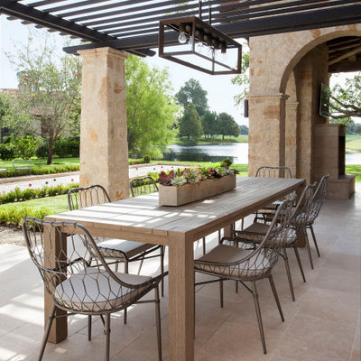 Tuscan patio photo in Houston with a pergola