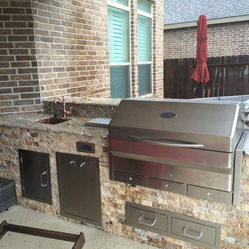 Houston Outdoor Kitchen With Memphis Wood Fire Grill and Scabos Split Face Stone