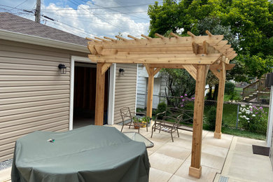 Example of a transitional backyard patio design with a pergola