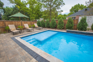 Pool - large backyard concrete paver pool idea in Indianapolis