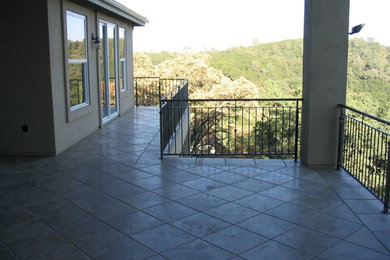 Example of a large classic tile patio design in Sacramento with a roof extension