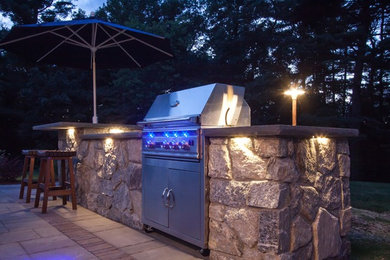 Example of a backyard patio kitchen design in Philadelphia with no cover