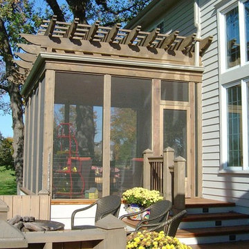Integrated screened porch with pergola roof and gutter system.
