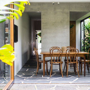 Photo of a tropical side yard patio in Sydney with a roof extension.
