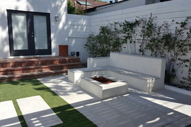 Small minimalist backyard concrete patio photo in Los Angeles with a fire pit and a gazebo