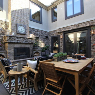 Elegant courtyard patio photo in San Diego with a fire pit