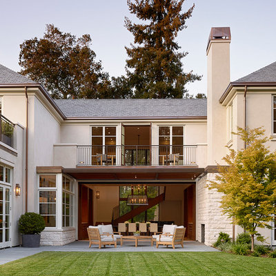 Example of a large classic backyard patio design in San Francisco with a roof extension