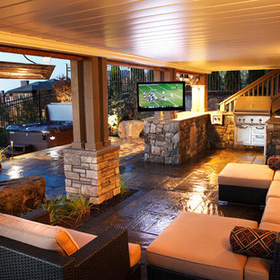 Patio kitchen - mid-sized rustic backyard stone patio kitchen idea in Seattle with a roof extension