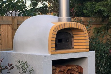 Patio kitchen - mid-sized mediterranean backyard concrete patio kitchen idea in Gold Coast - Tweed with no cover
