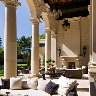 Example of a tuscan patio design in Minneapolis with a fire pit