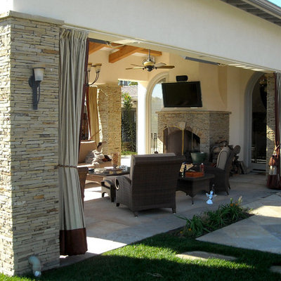 Example of a trendy patio design in San Diego with a fire pit and a pergola