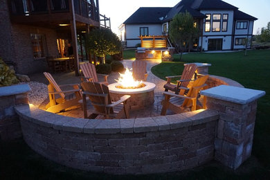 Mid-sized transitional backyard concrete paver patio photo in Other with a fire pit