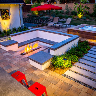 Patio - large contemporary backyard concrete paver patio idea in Tampa with a fire pit and no cover