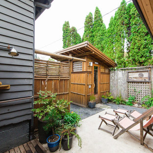 Asian backyard concrete patio photo in Portland with no cover