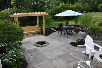 Inspiration for a mid-sized transitional backyard tile patio remodel in Cleveland with a fire pit and no cover