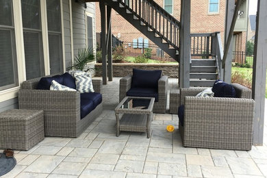 Inspiration for a mid-sized modern backyard concrete paver patio remodel in Raleigh with a roof extension