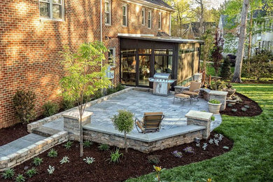Example of a mid-sized classic backyard concrete paver patio design in Raleigh with no cover