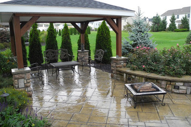 Inspiration for a timeless backyard patio remodel in Philadelphia with a fire pit and a pergola