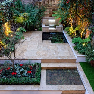 Design ideas for a small classic back patio in London with a water feature and natural stone paving.