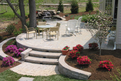 Design ideas for a medium sized classic back patio in Baltimore with concrete paving, no cover and a water feature.