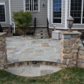 Kidney Shaped Flagstone Patio with Fireplace and Lights