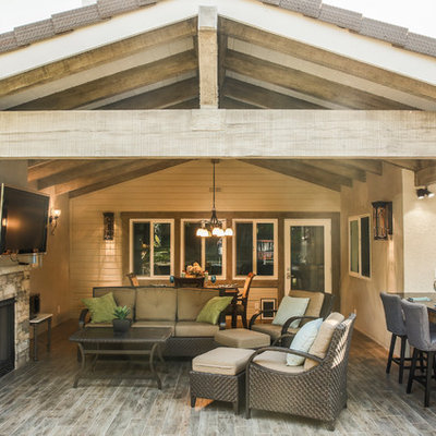Mid-sized elegant backyard patio kitchen photo in Los Angeles with decking and a roof extension